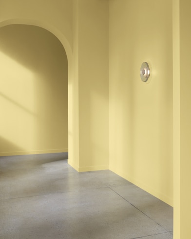 An arched hallway in a modern home is painted Spring Dust.